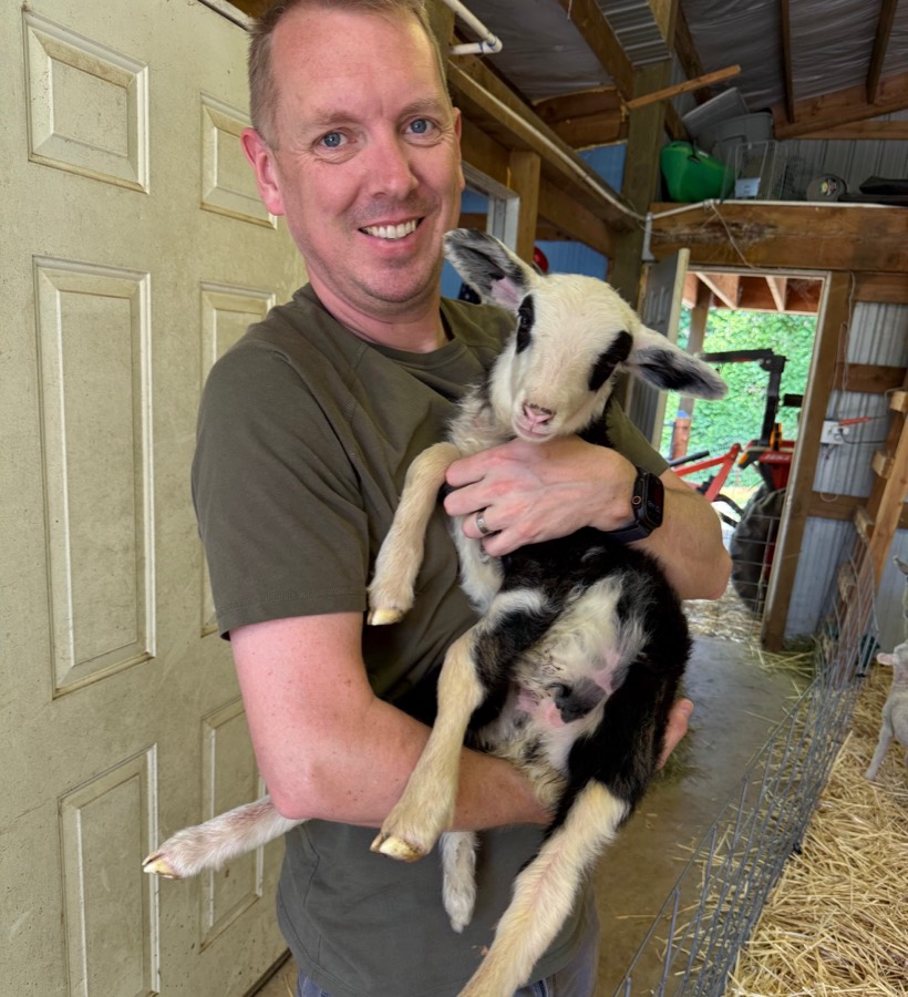 Casey Hettman with a lamb